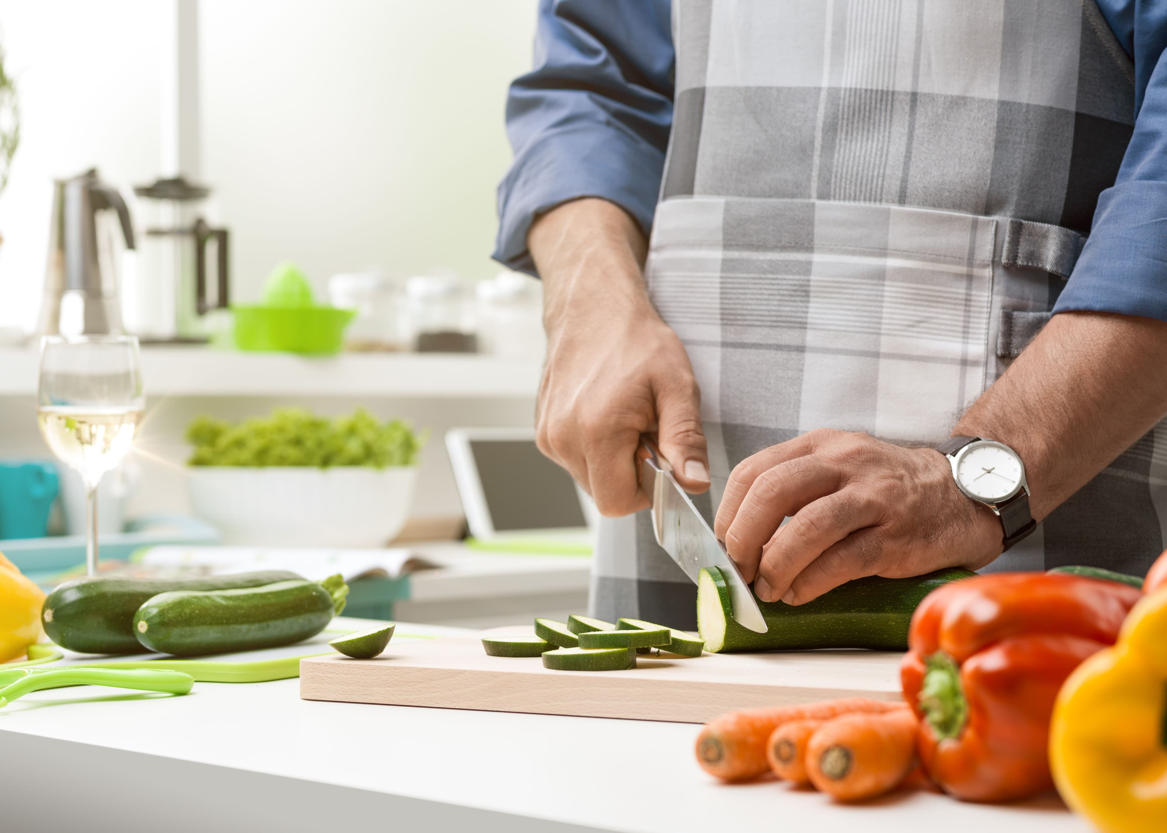 man cutting cucumbers